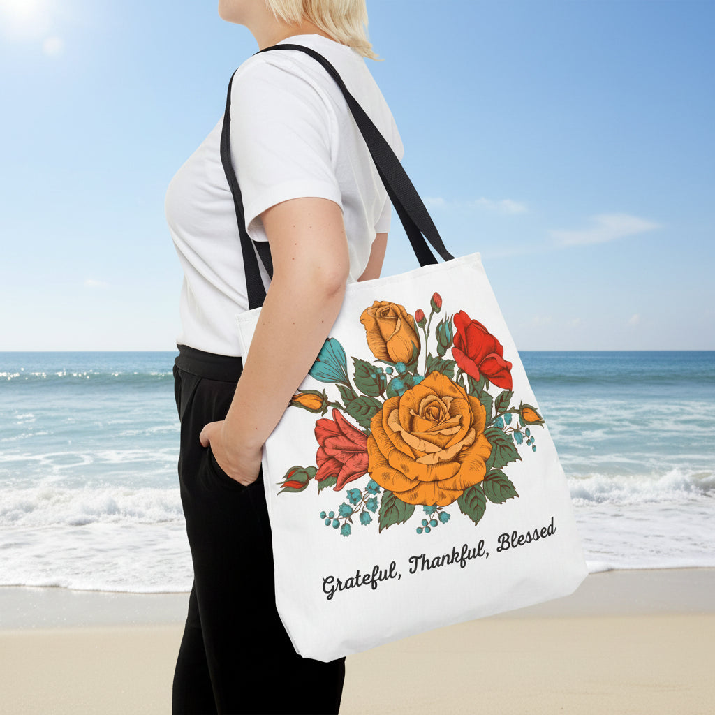 Person holding a tote bag with floral design and text on a white background